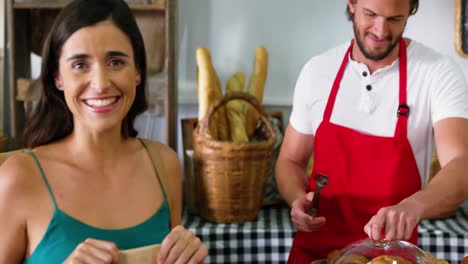 Woman-purchasing-bread-at-bakery-store