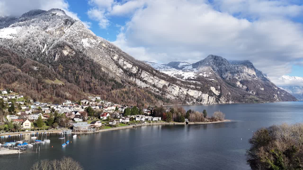 Snowy mountain village and lake shoreline at Walensee under soft daylight