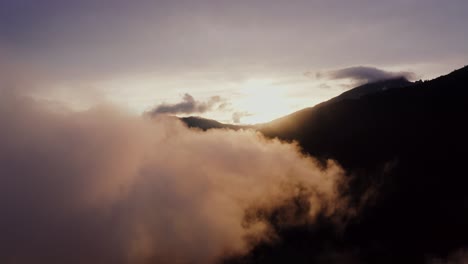 sunrise or sunset over mountain peaks with clouds