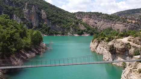 congost de mont rebei canyon at ager, catalonia and aragon, spain - aerial drone view of the bridge over blue emerald noguera ribagorzana river lake