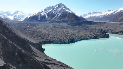 tasman lake with long glacier in valley and snow capped mountains