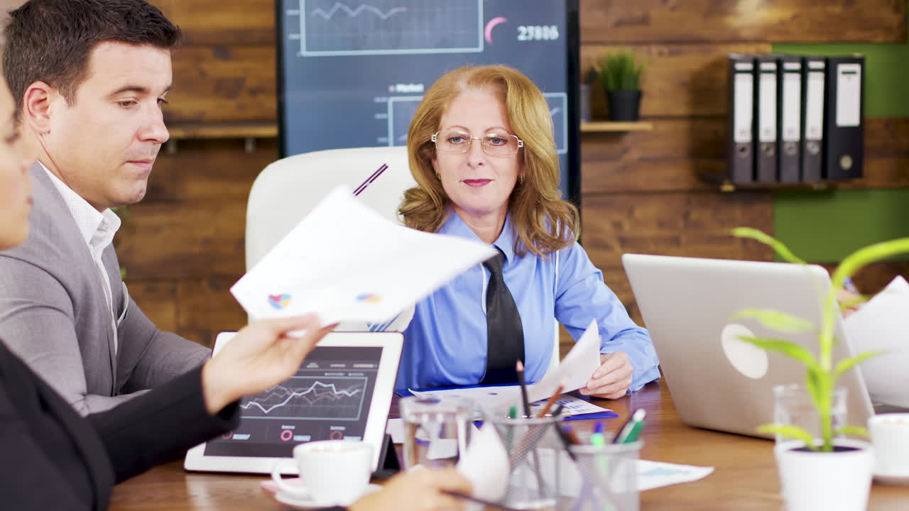 Corporate female business trainer discussing financial graph
