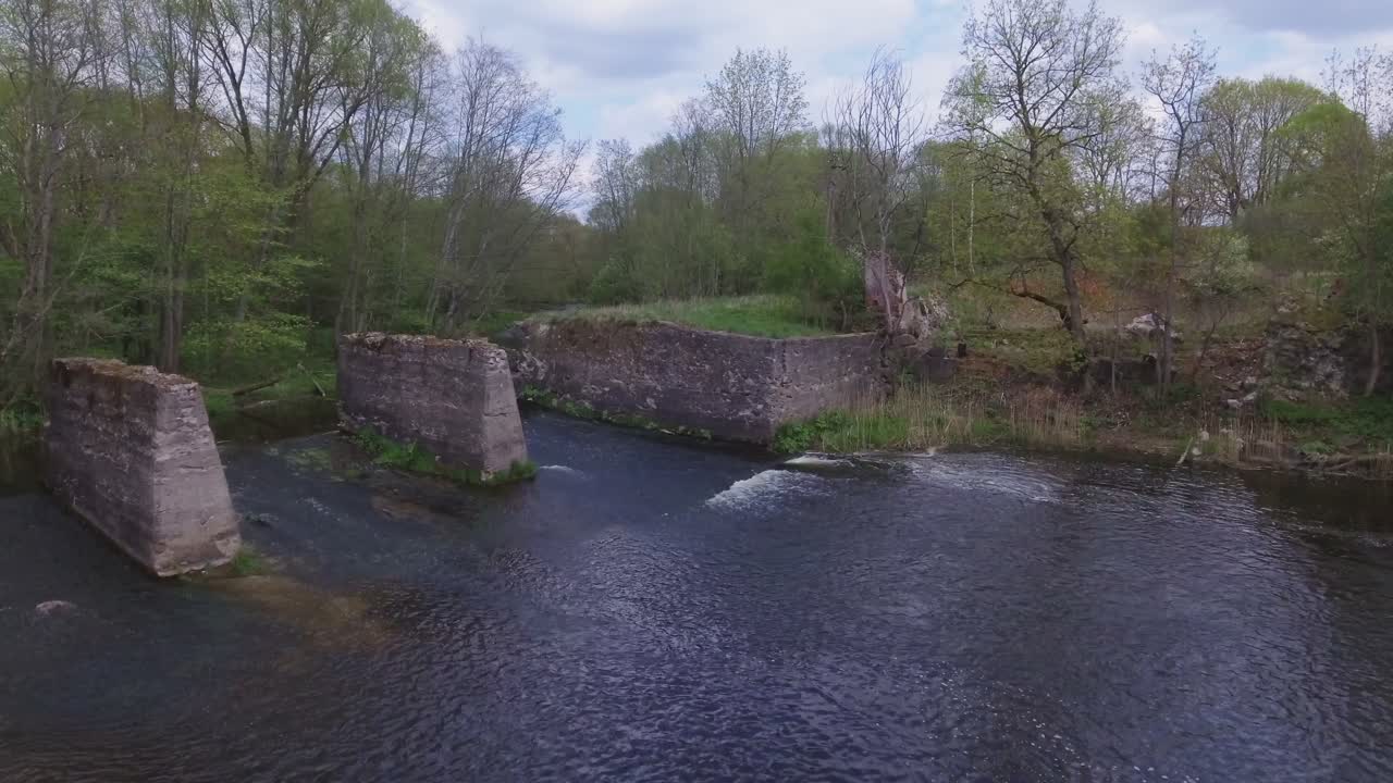 Remains of the watermill of fragments of Musninkai (Musninkeliai) manor homestead. 4K aerial dolly-in