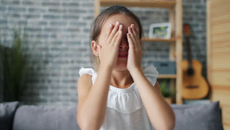 young girl hiding face