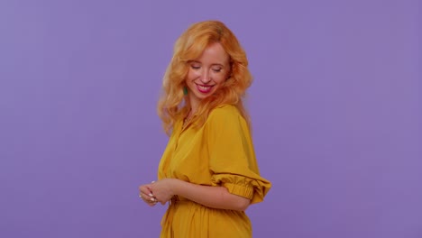 cheerful lovely long haired lovely girl fashion model in yellow dress smiling and looking at camera