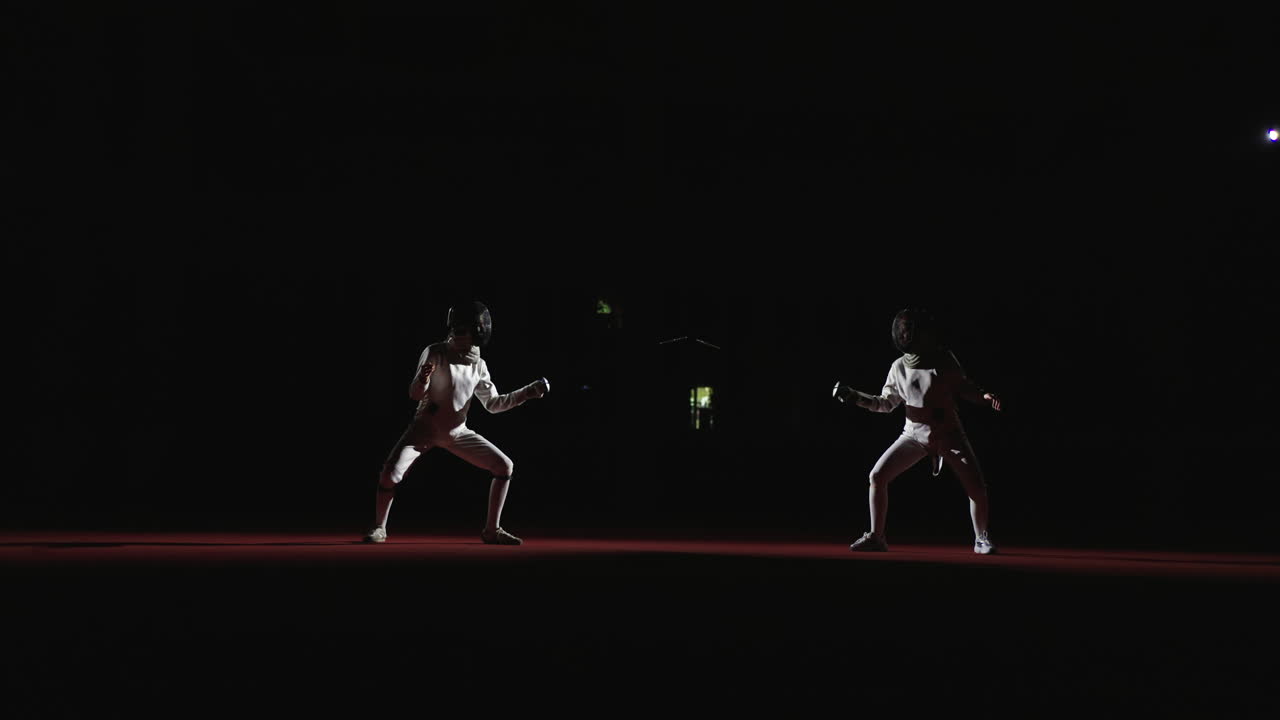 Two fencers in a competitive fencing match