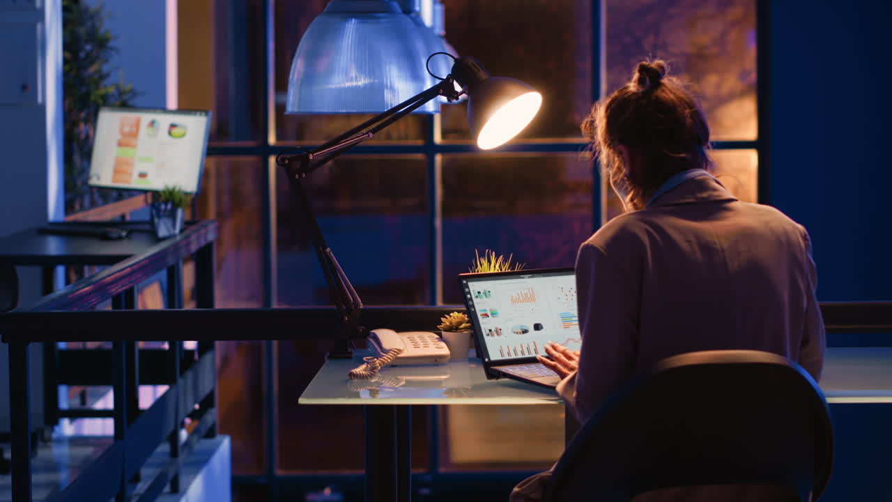 Office workspace with woman working on laptop