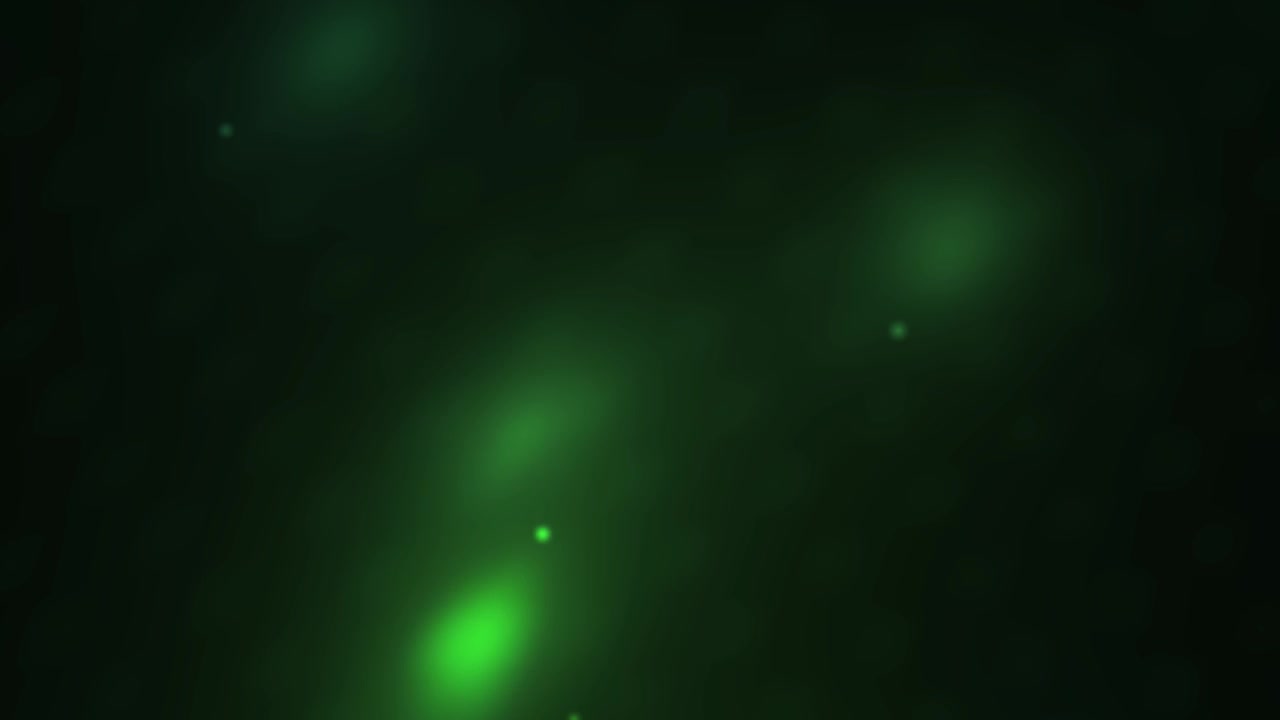 Bagliori di Luce Verdi Astratti e Particelle Bokeh su Sfondo Scuro