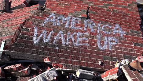 graffiti on a ruined building following the ferguson rioting urges america to wake up