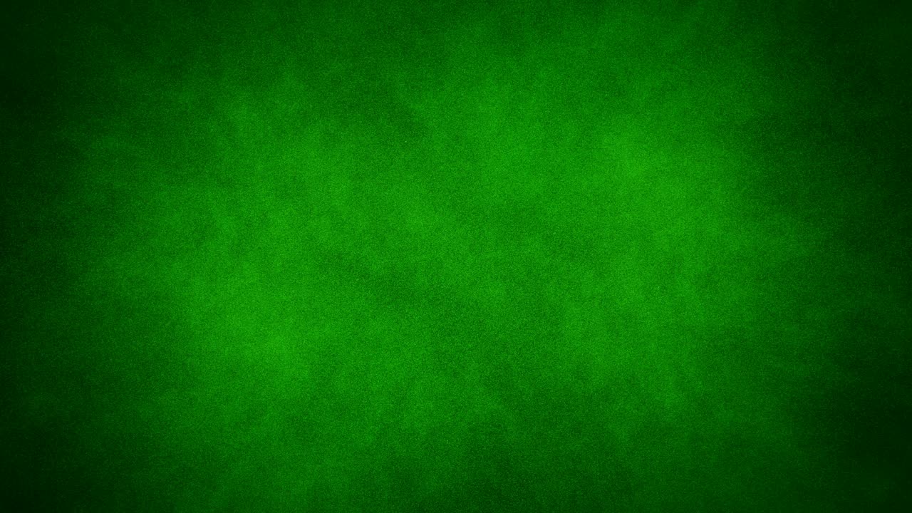 A spray of green paint paints over a black background forming a green chroma key
