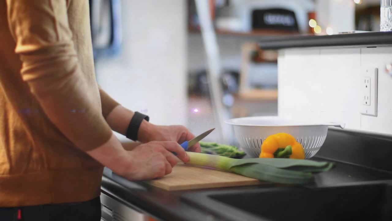 Home cook slicing leek for recipe on countertop causing electric arcs purple flare, lightning bolts
