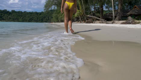 hot asian model walking away, low angle, on a tropical beach, koh kood, thailand