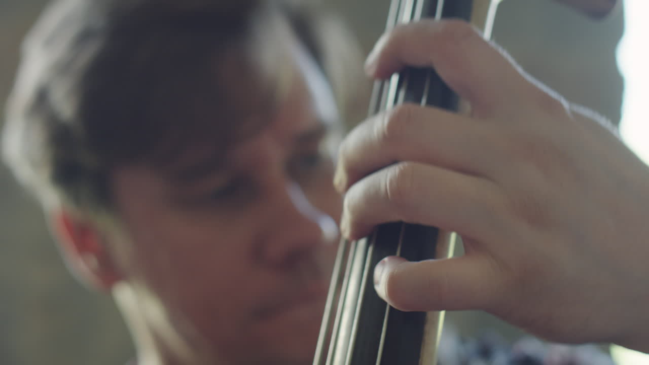Close-up of a musician playing a string instrument