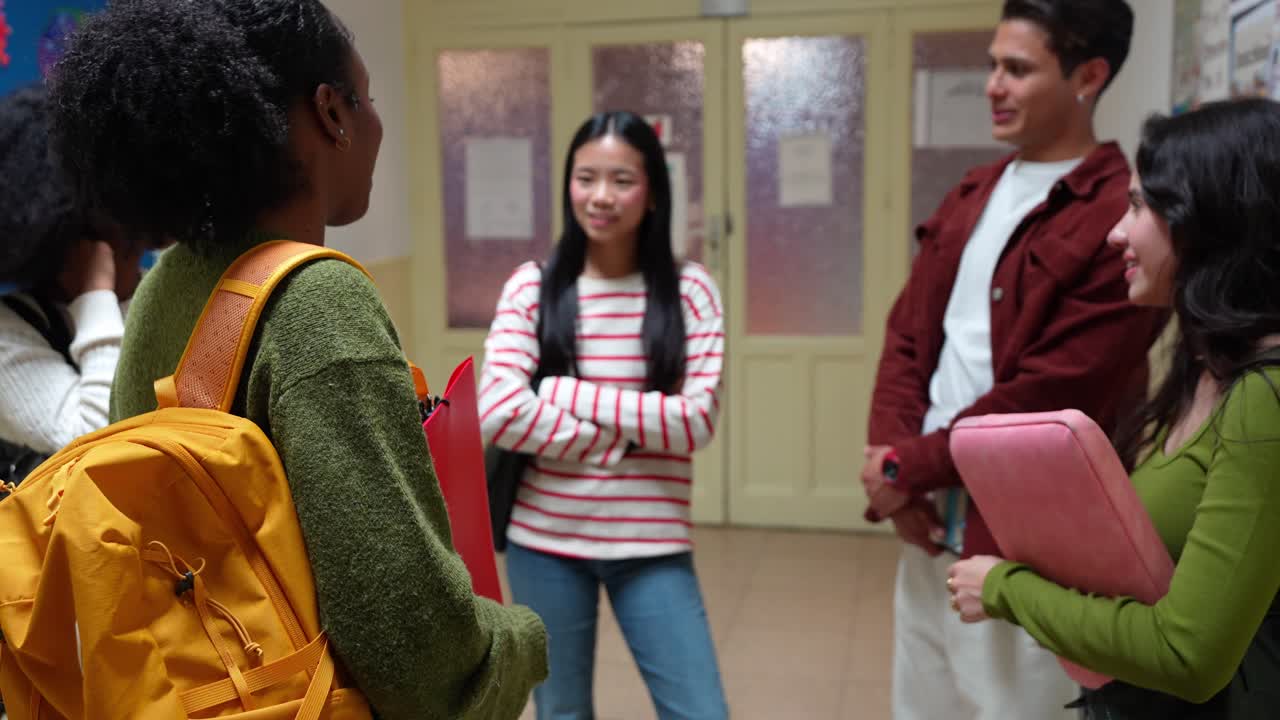 Diverse Group of Young Students Talking in School Hallway