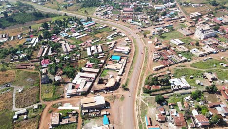 Aerial-view-of-cars-and-people-at-a-Open-Air-Market,-in-Africa---reverse,-drone-shot