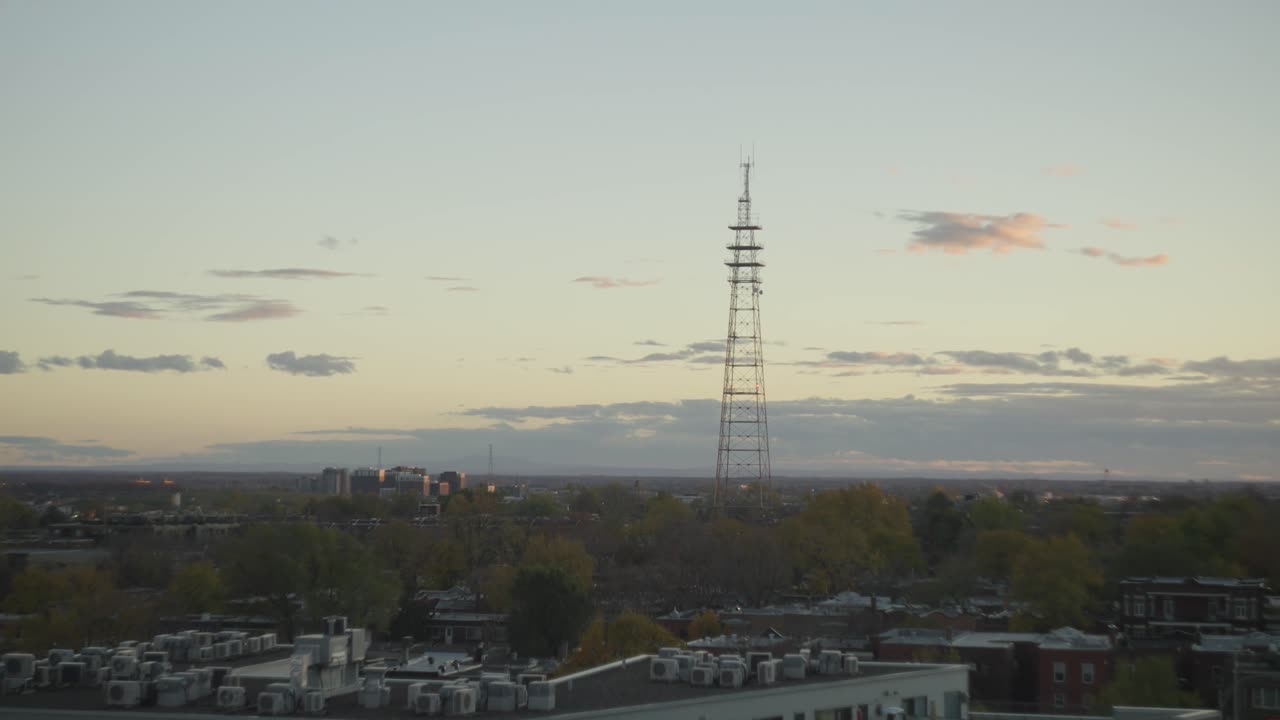 Television Transmission Lattice Tower At Dusk With Industrial Building In The Foreground In Westmount, Montreal, Canada. - wide shot