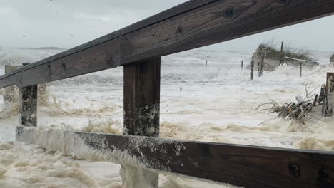 florida hurricane waves and surge flood beach dunes, walkway and destroy fence