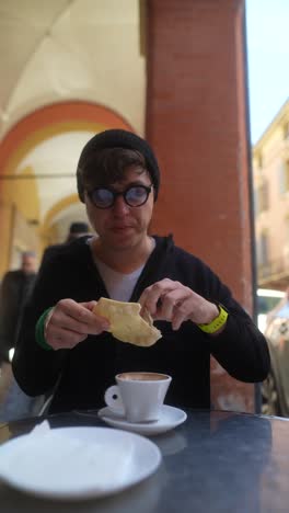 person eating bread and drinking coffee outdoors in italy