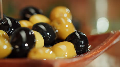 pouring oil on olives