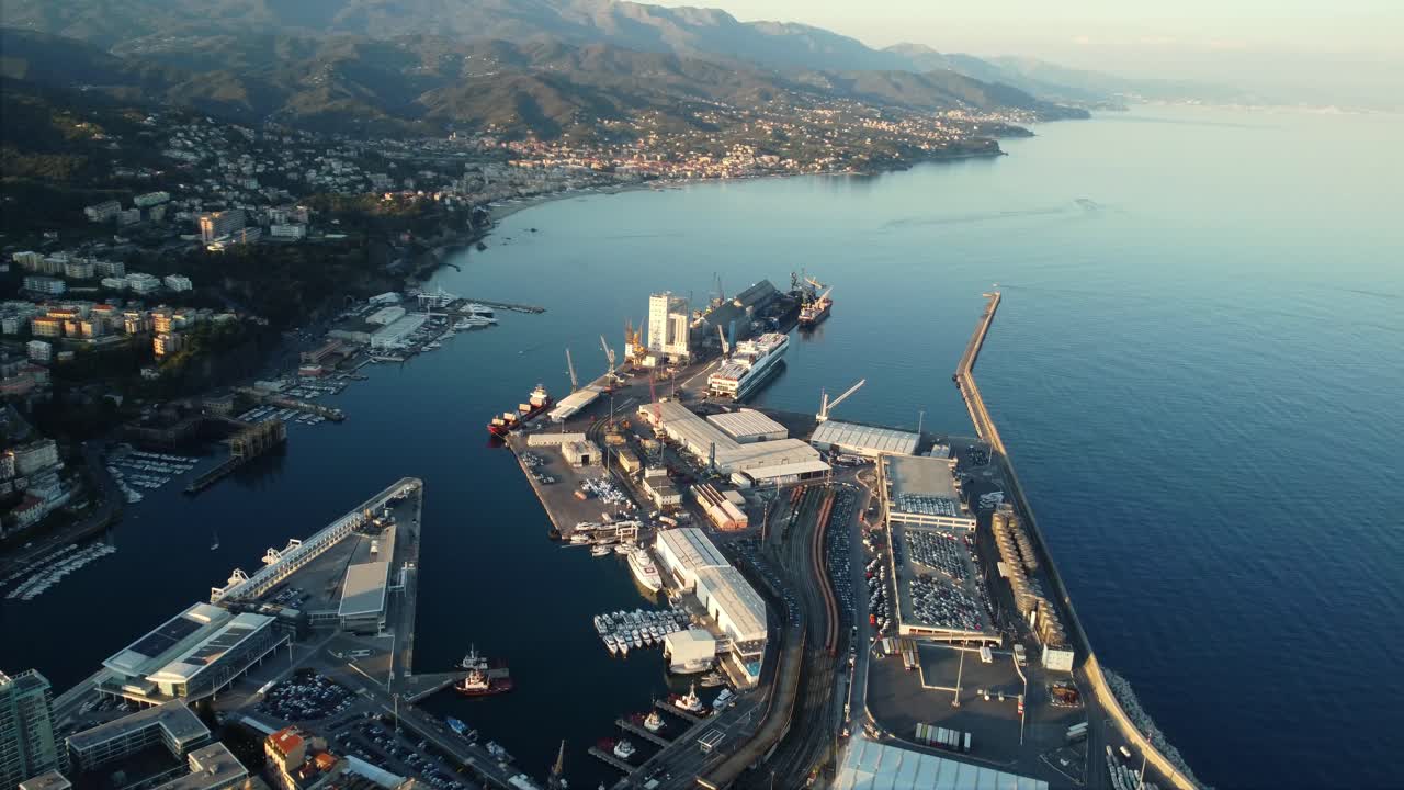 Aerial View of a Busy Port City with Mountains in the Background