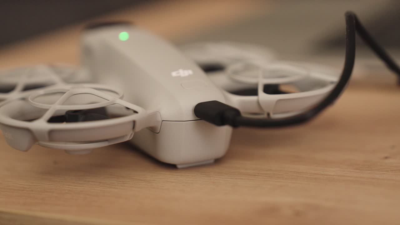 Static shot of black wire connected to drone data transfer port, Czechia