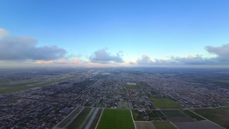flight among and over the light clouds. fpv drone footage above the vast urban landscape at daytime.