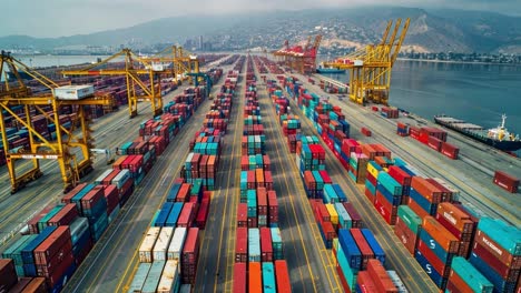 aerial view of a large container port with stacks of shipping containers and cranes