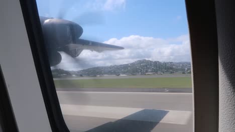 plane seat view of propellers taking off on a sunny day