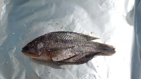 Preparing-tilapia-fish-with-pepper-onions-and-garlic