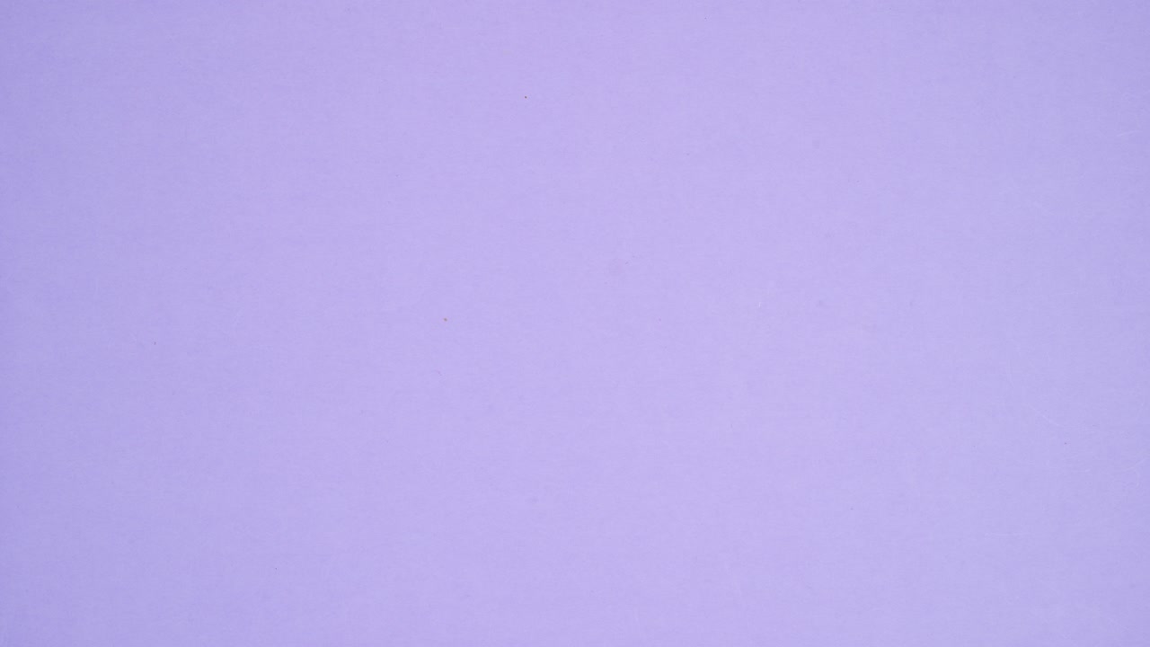 Gummy candies chocolate candies and lollipops appear on bottom of pastel purple background. Stop motion flat lay