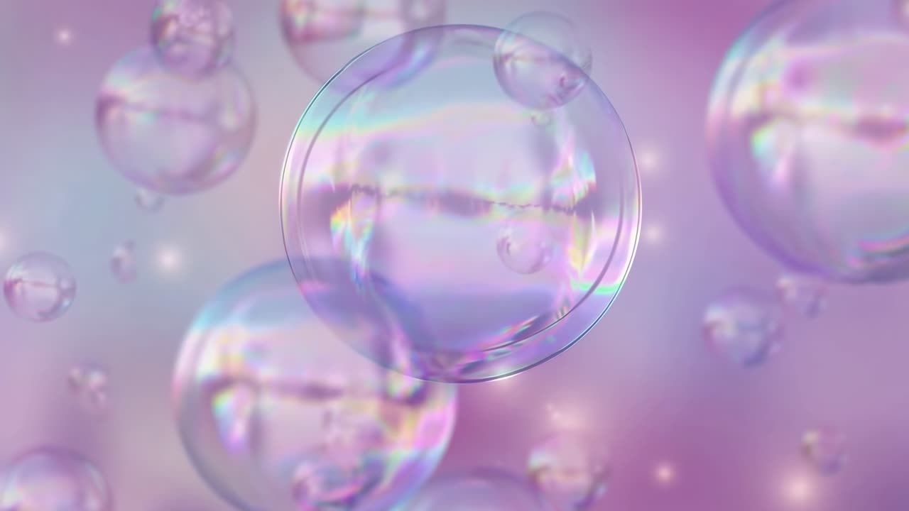 Dreamy close-up video of iridescent bubbles floating against a soft pink background