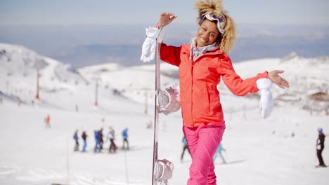 excited skier waving from top of slope