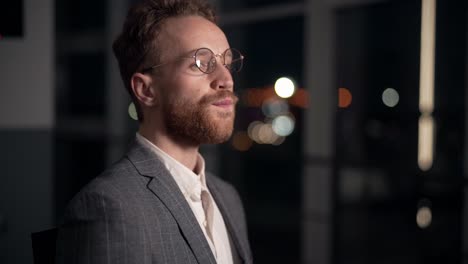 close-up portrait of handsome man working in office at table drinking water