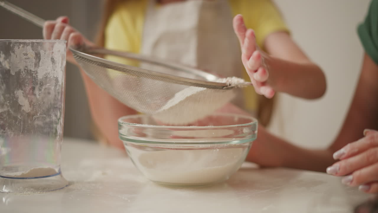 Little Girl Sifting Flour for Baking