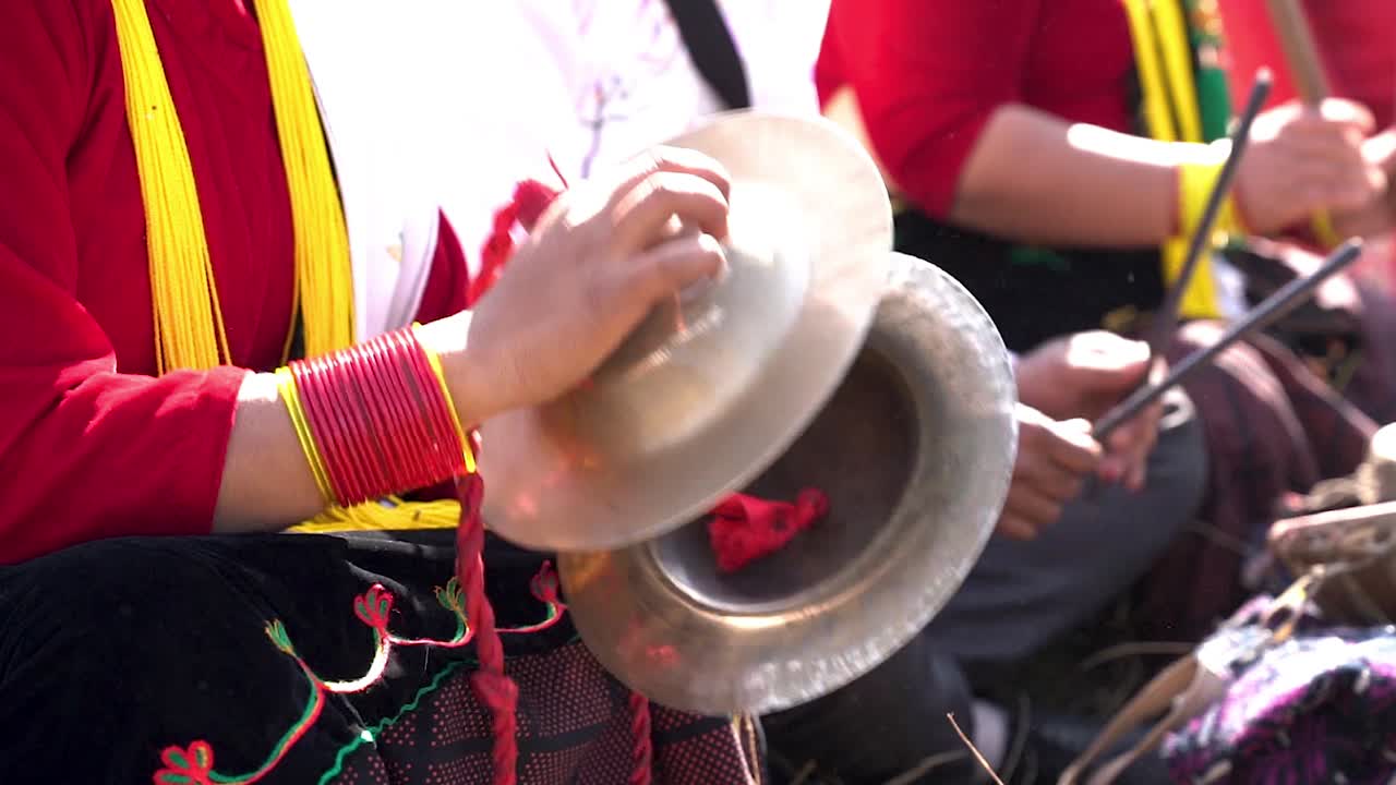 Close up of a woman playing an old Nepali instrument during the celebration