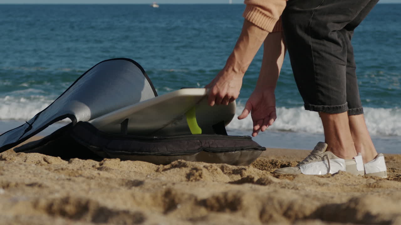 Surfer man walking to the beach at sunset preparing for surfing training and search for waves in Barcelona, spain, water, ocean exercise in sea with board, athletic male holiday or travel in vacation