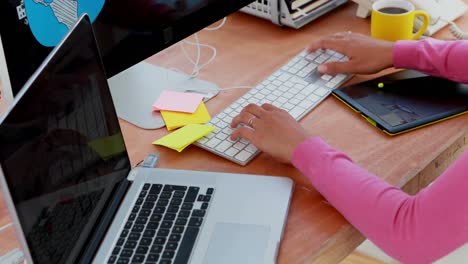 female graphic designer working at desk 4k