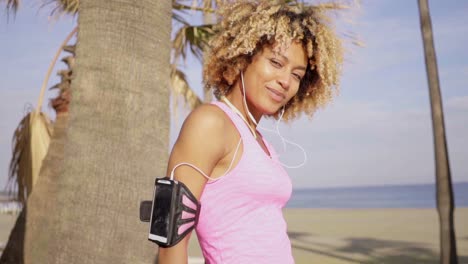 Confident-fit-woman-with-arm-band-music-player