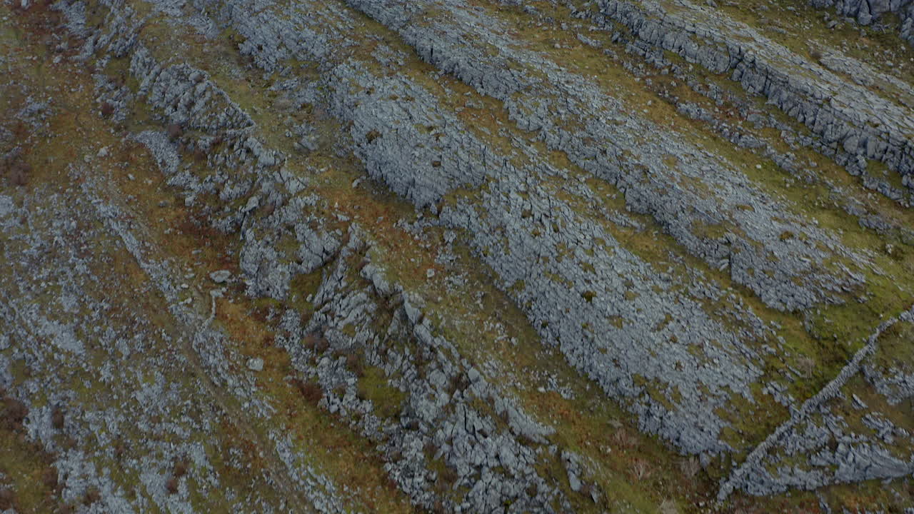 Aerial top-down dolly exploring rugged Burren hills and revealing stunning views. County Clare