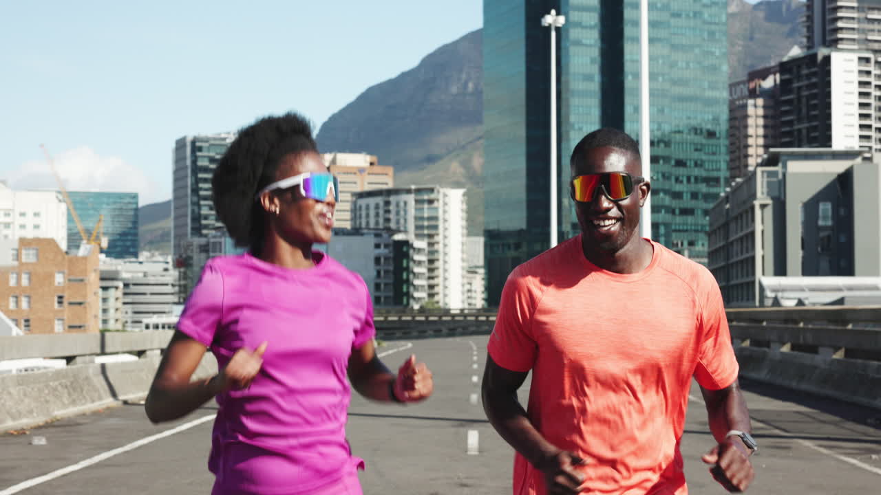 Happy Black Couple Running Together on a City Street