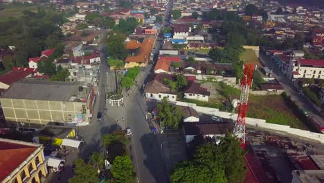 a beautiful sunny day in coban city that has trees near the streets.
