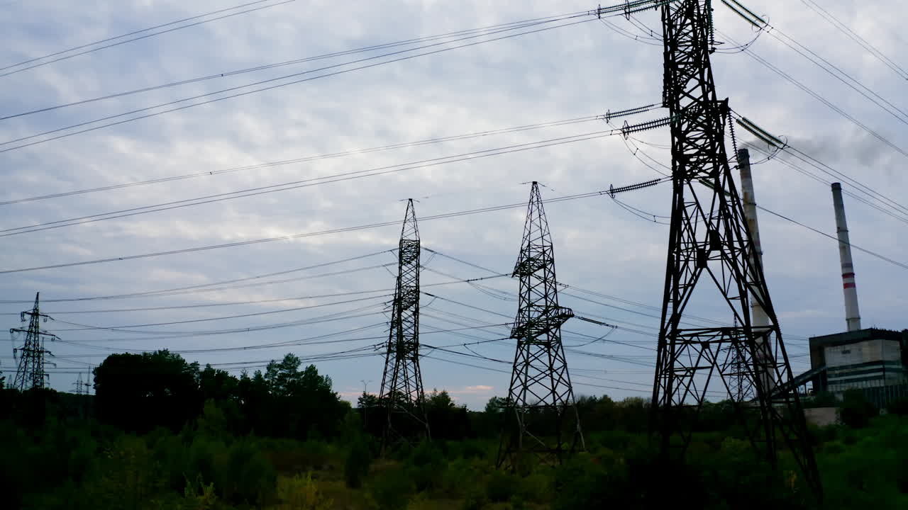 High voltage post. High voltage pylons against sunset background. Energy and industrialisation concept. Selective focus