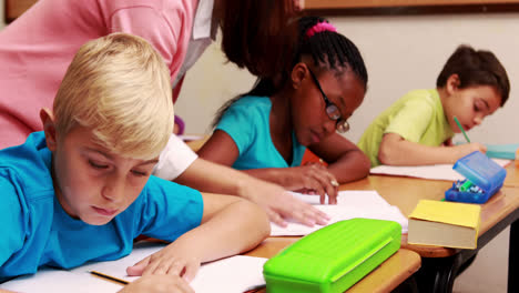 young teacher helping her pupils