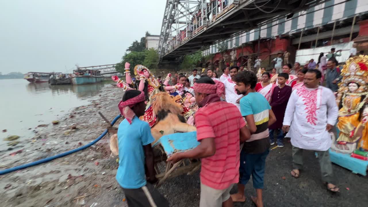 Men carrying Durga idol for immersing into holy Ganga river in Kolkata, India. Durga Puja last day.