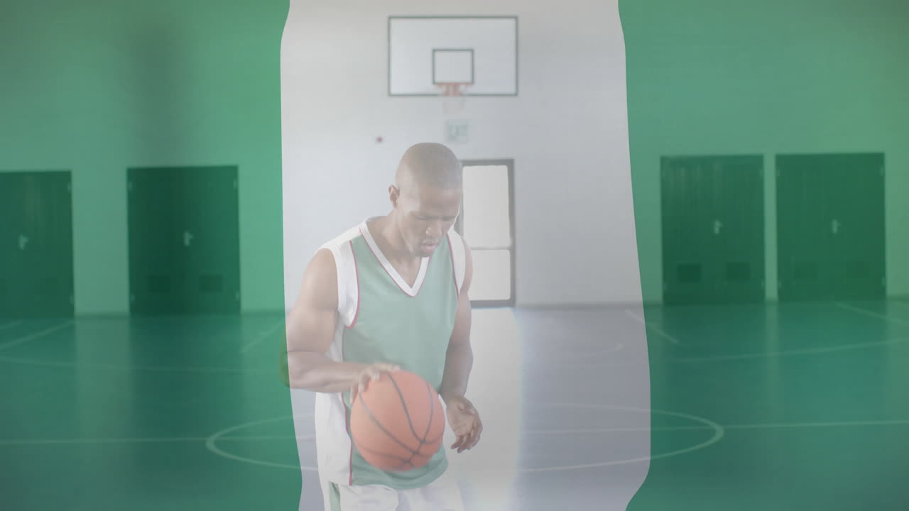 animación de la bandera de nigeria sobre el jugador de baloncesto afroamericano en la cancha