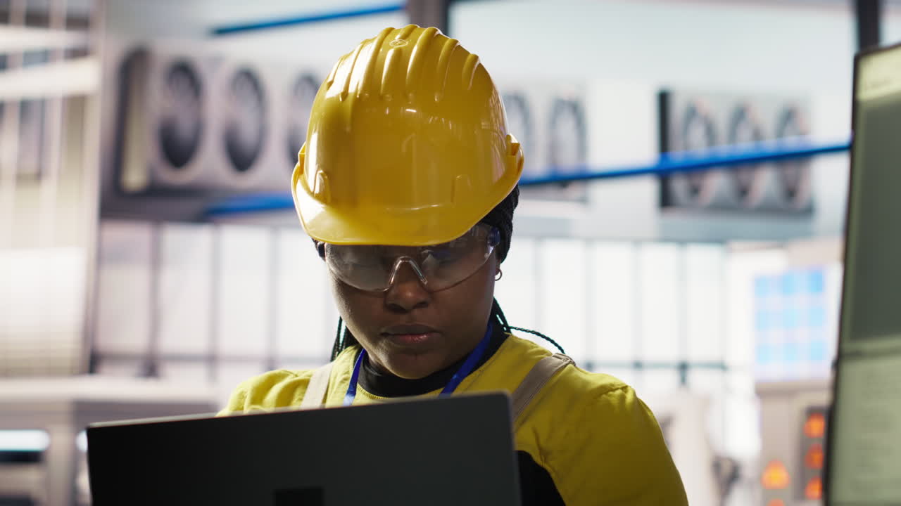 Vertical video Smiling smart factory specialist testing automated systems to ensure reliability