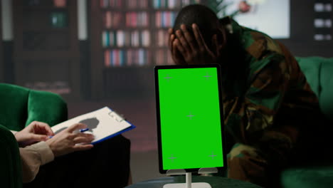 un soldado afroamericano en terapia comparte el trauma de la guerra junto a chroma key.