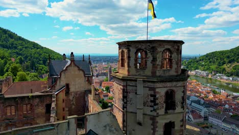 4k aerial drone video of ruins of the historic castle on königstuhl hill overlooking heidelberg, germany along the neckar river
