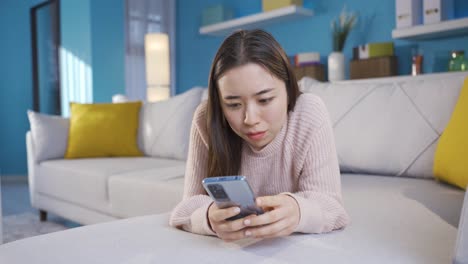 asian young woman spending time at home using mobile phone technology.