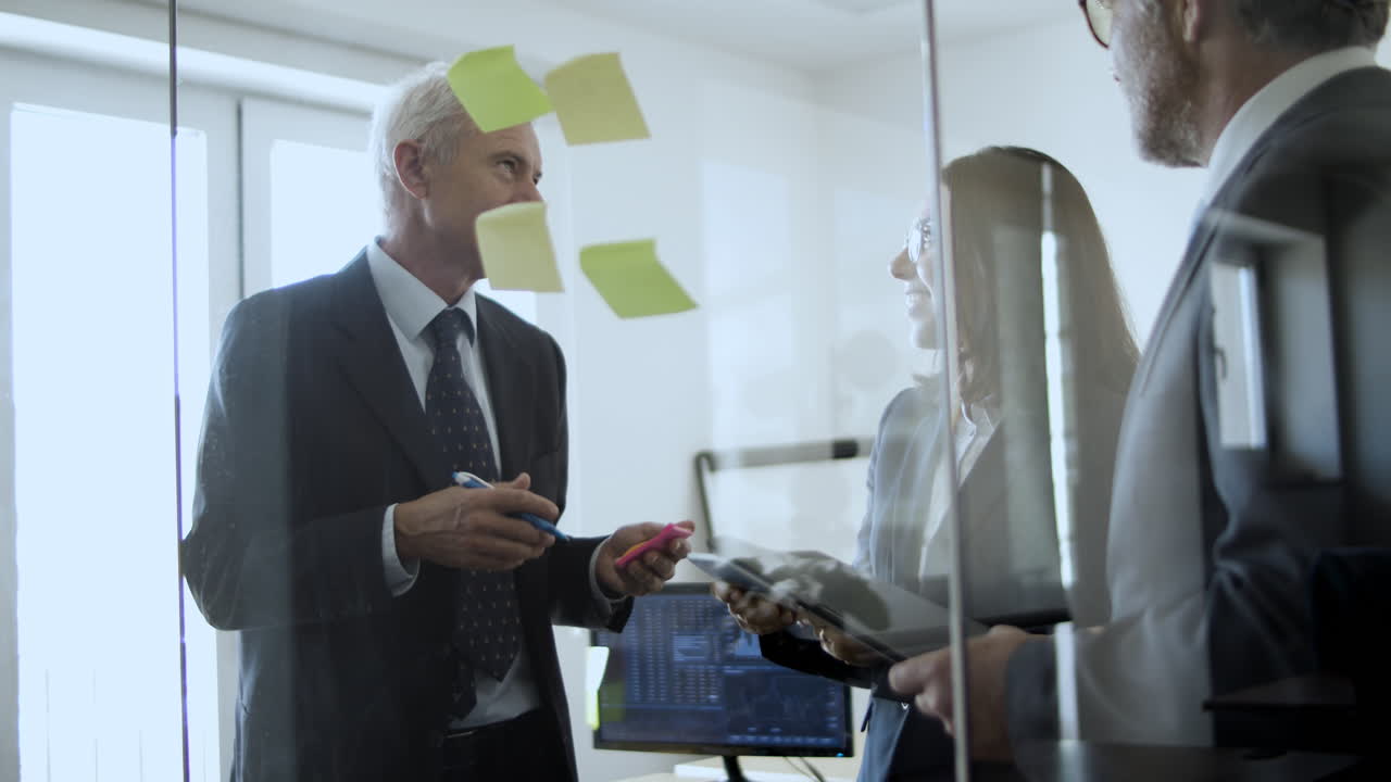 Mature company leaders and young project manager in a meeting